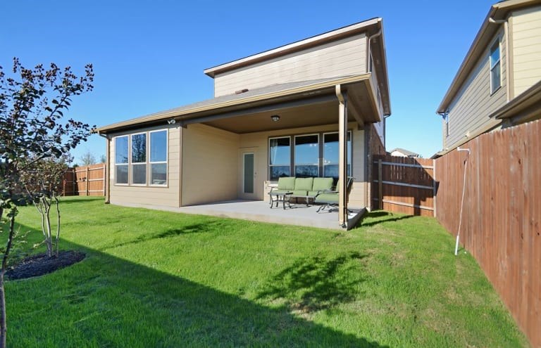 16017 Travesia Way Austin, TX 78728 - Photo 12 of 12 a view of a backyard with table and chairs and potted plants with wooden fence