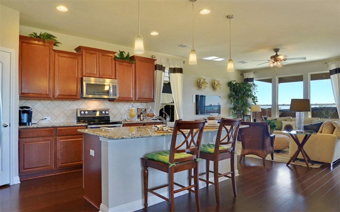 16017 Travesia Way Austin, TX 78728 - Photo 5 of 12 a large kitchen with a table and chairs