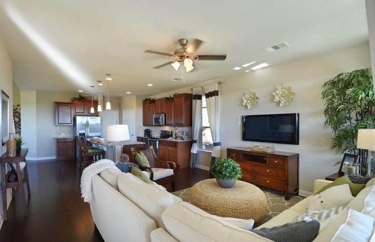 16017 Travesia Way Austin, TX 78728 - Photo 6 of 12 a living room with furniture a fireplace and a flat screen tv