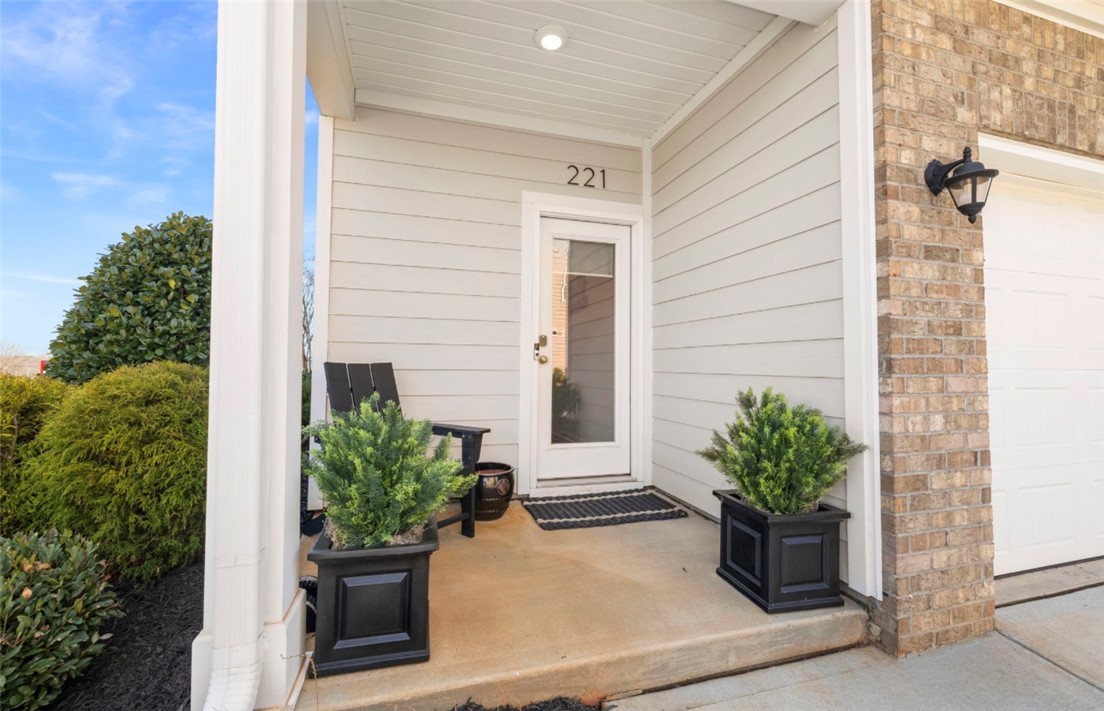 221 Scenic Drive Anderson, SC 29621 - Photo 23 of 27 This charming front entrance offers a welcoming porch, blending classic brick with modern siding.