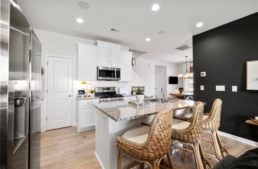 221 Scenic Drive Anderson, SC 29621 - Photo 5 of 27 This bright kitchen features an island, ample counter space, and modern appliances perfect for daily living.
