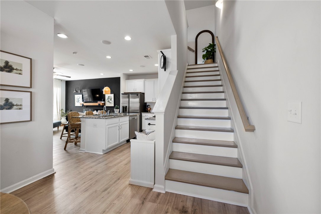 221 Scenic Drive Anderson, SC 29621 - Photo 7 of 27 This inviting interior features an open layout connecting the kitchen and living areas, with sleek wood flooring.
