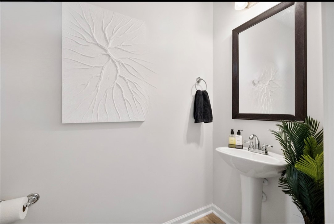 221 Scenic Drive Anderson, SC 29621 - Photo 8 of 27 This clean and inviting powder room features a pedestal sink and modern fixtures, offering convenience and style.