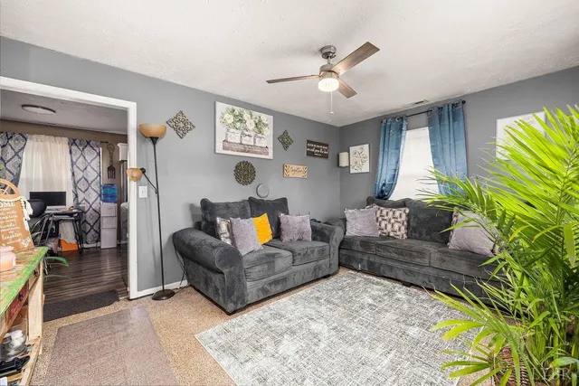 a living room with furniture and a chandelier