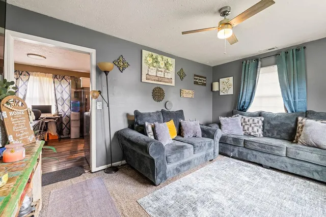 a living room with furniture and a large window