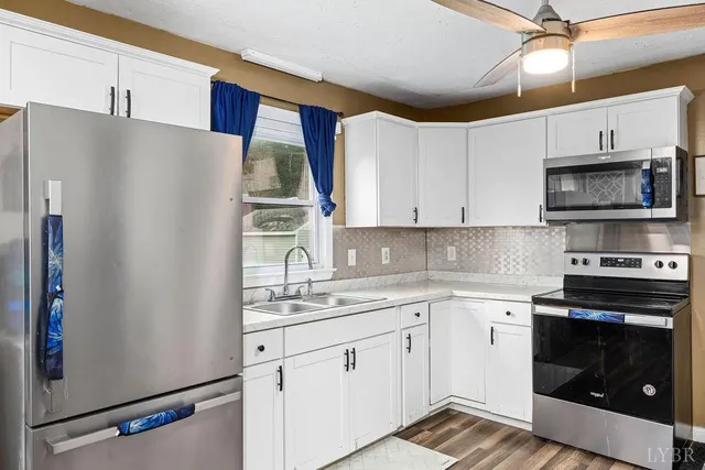a kitchen with a sink appliances and cabinets