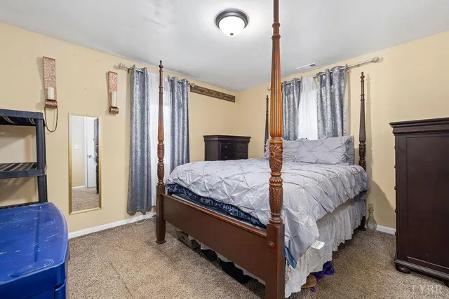 a bedroom with a bed lamp and a dresser