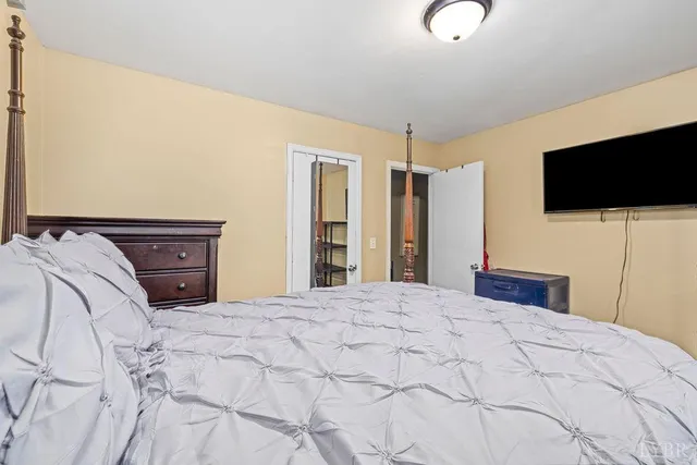 a bedroom with a bed and a flat screen tv
