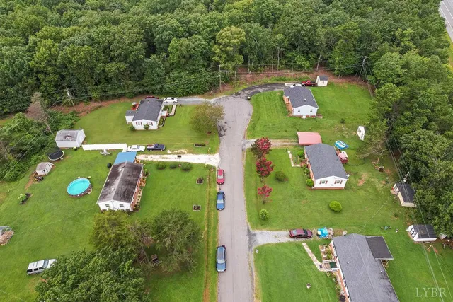 an aerial view of a pool patio fire pit and outdoor seating