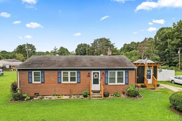 a aerial view of a house with yard and swimming pool