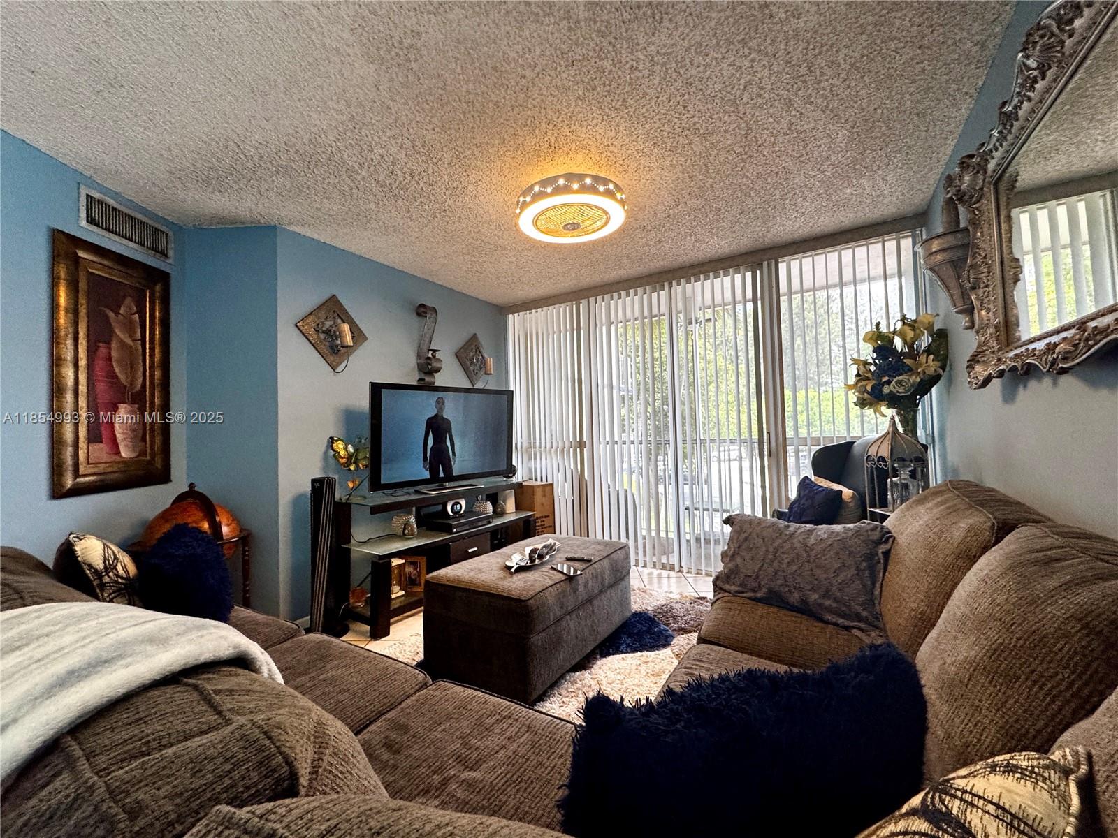 7165 Northwest 186th Street, Unit A211 Hialeah, FL 33015 - Photo 3 of 15 a bedroom with furniture and a window