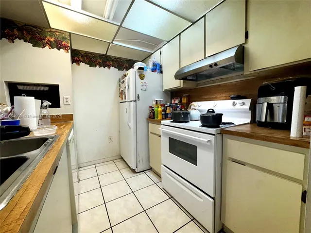 a kitchen with stainless steel appliances a stove a sink and a refrigerator
