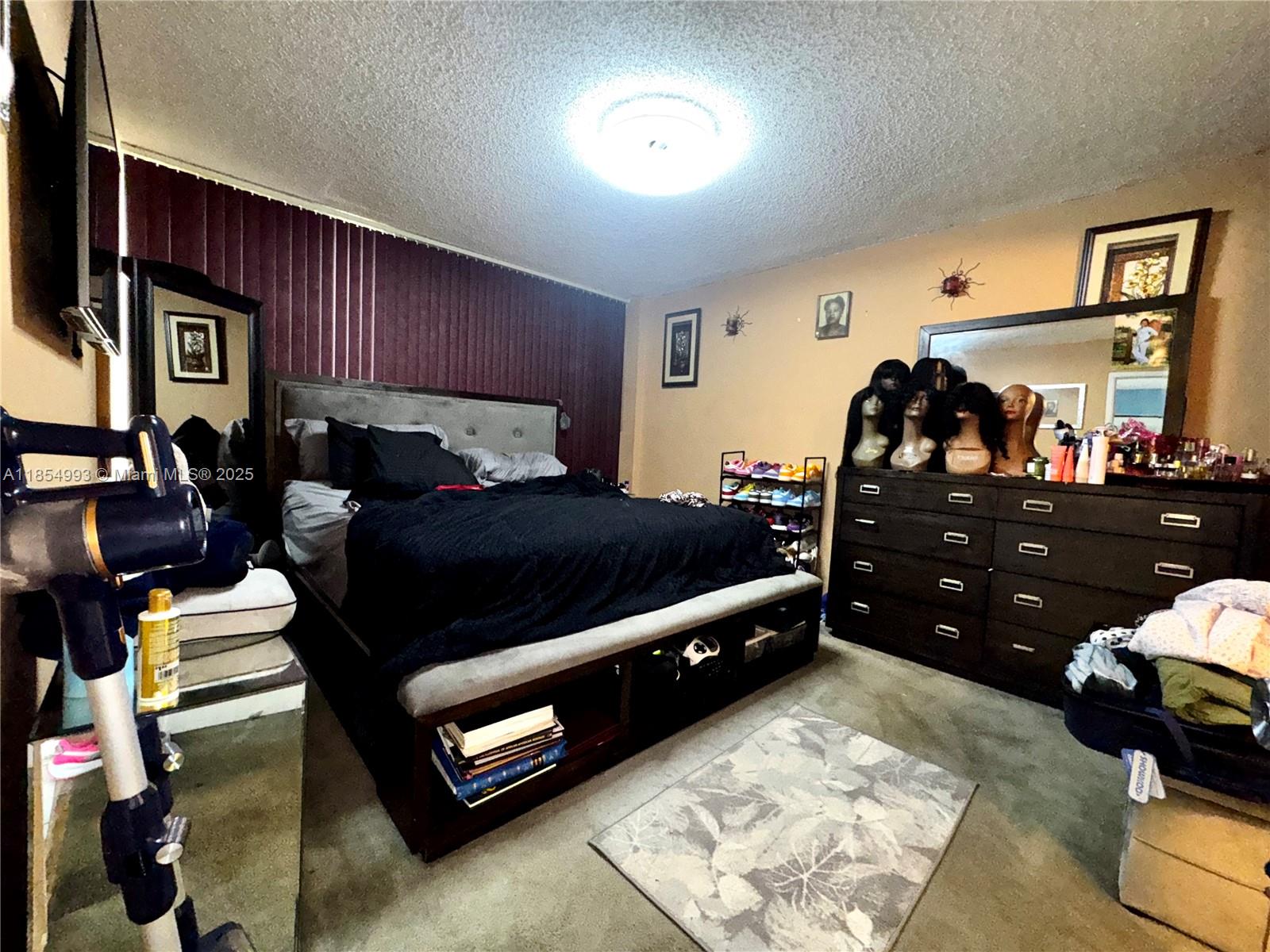 7165 Northwest 186th Street, Unit A211 Hialeah, FL 33015 - Photo 7 of 15 a living room with furniture and a flat screen tv