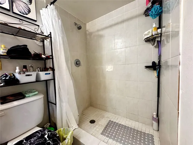 a bathroom with a shower and a toilet