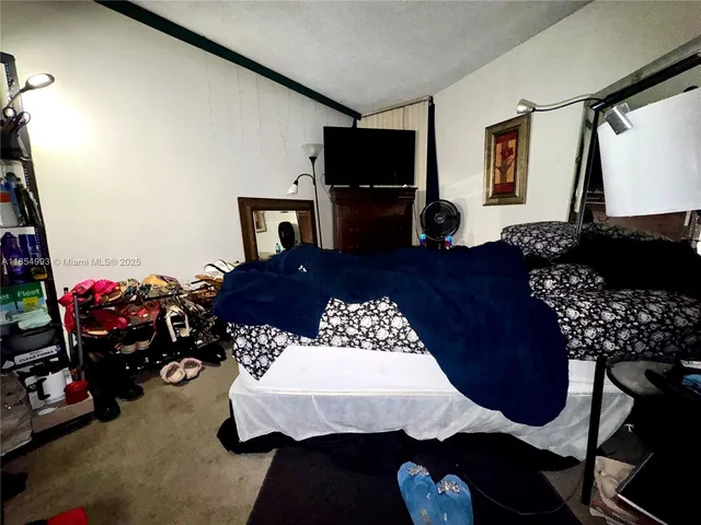 a bedroom with a bed window and dresser