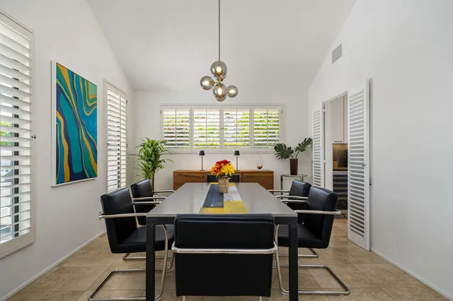a view of a dining room with furniture and window
