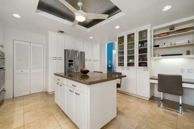 a kitchen with stainless steel appliances granite countertop a stove and a refrigerator