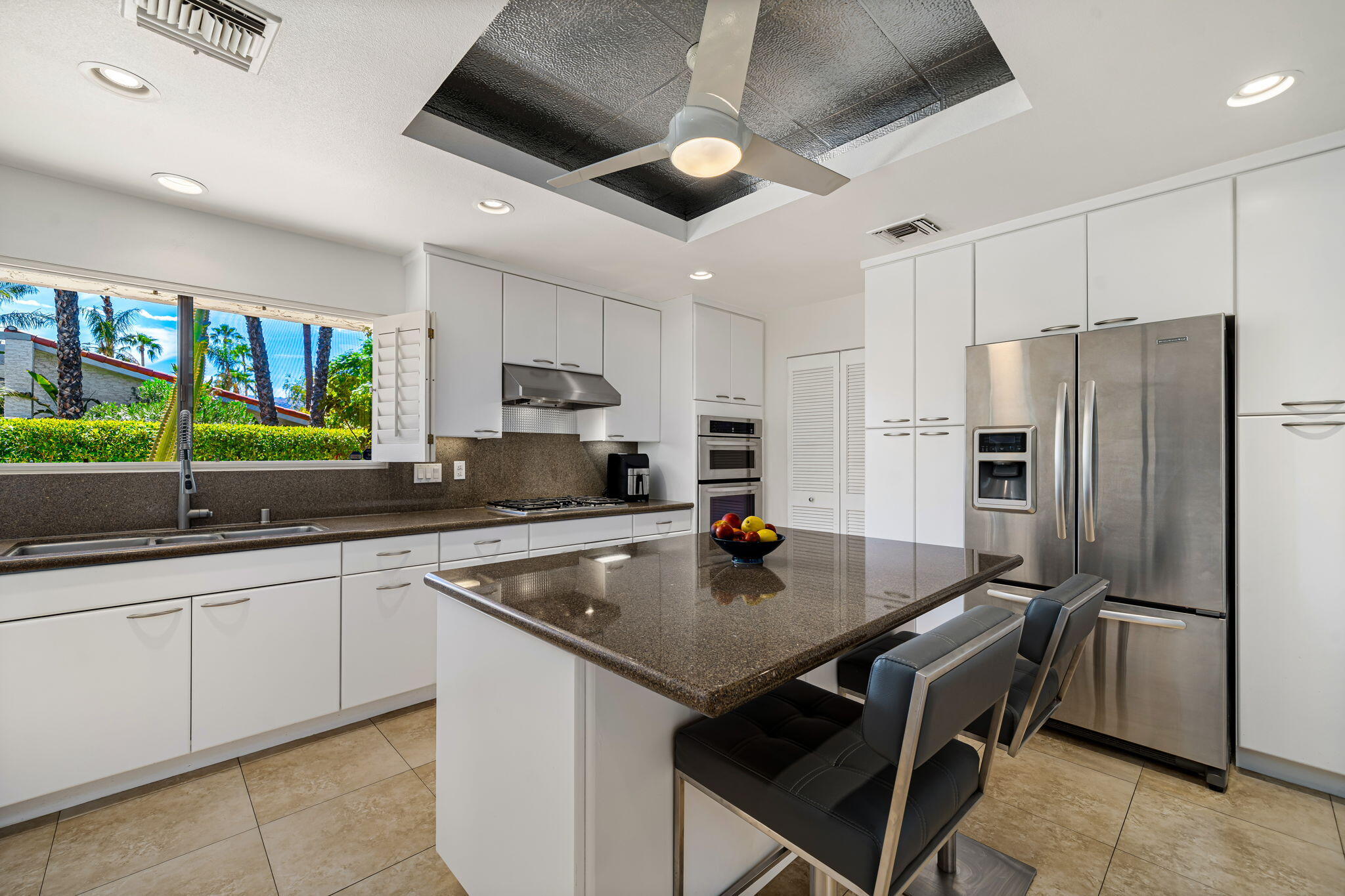 41 Lincoln Place Rancho Mirage, CA 92270 - Photo 15 of 37 a kitchen with a sink a counter space stainless steel appliances and cabinets