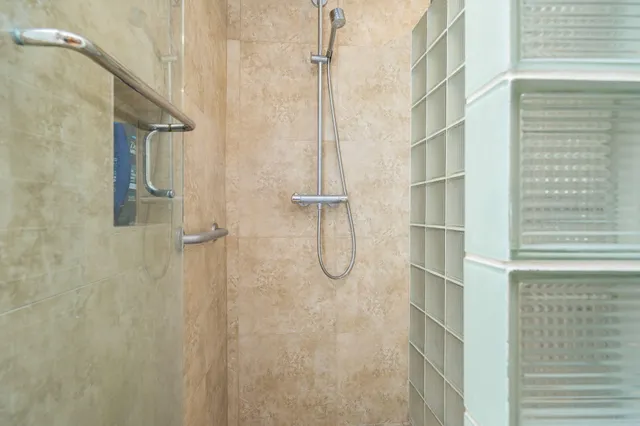 a bathroom with a glass shower door