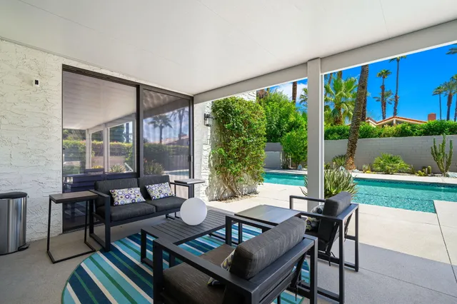 a outdoor space with patio the couches and a dining table with garden view