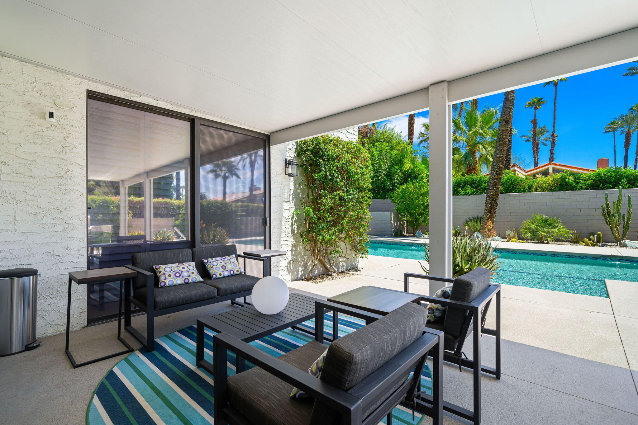 41 Lincoln Place Rancho Mirage, CA 92270 - Photo 29 of 37 a outdoor space with patio the couches and a dining table with garden view