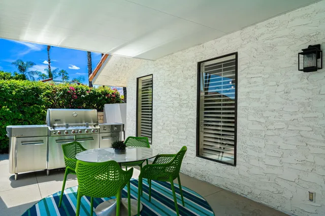 a view of backyard with outdoor seating and plants