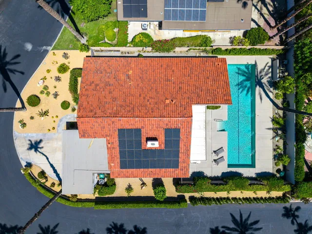 an aerial view of a house with a swimming pool