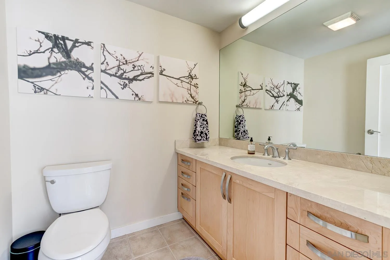 5440 La Jolla Boulevard, Unit E208 La Jolla, CA 92037 - Photo 20 of 35 a bathroom with a granite countertop toilet sink and mirror
