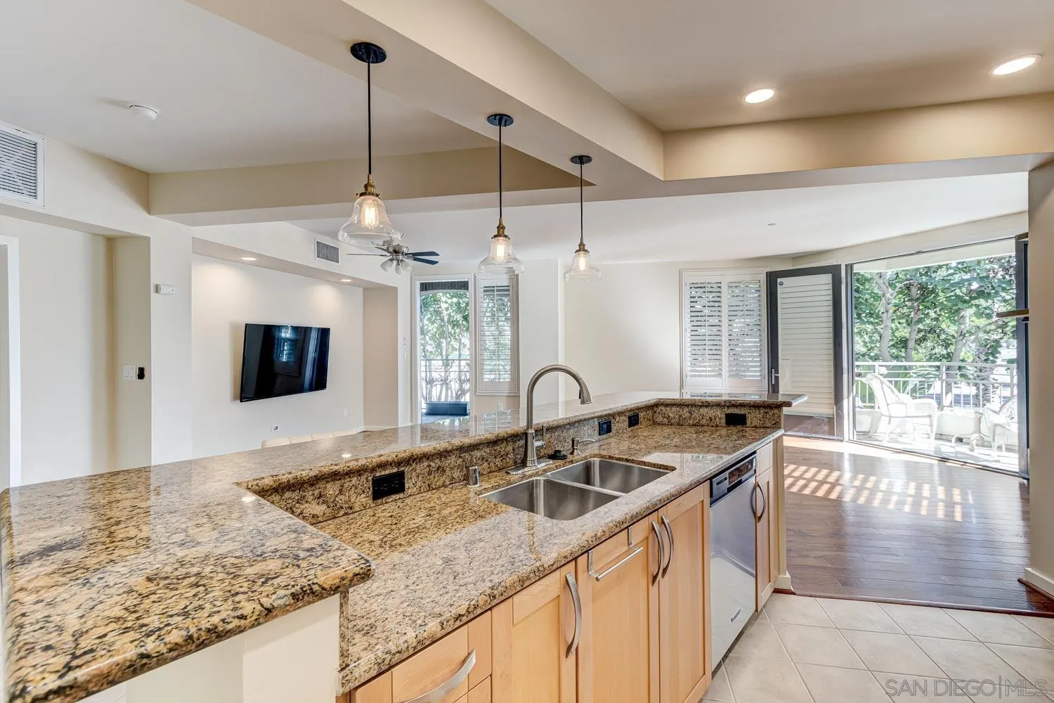 5440 La Jolla Boulevard, Unit E208 La Jolla, CA 92037 - Photo 5 of 35 a kitchen with stainless steel appliances granite countertop a sink a stove and a wooden cabinets
