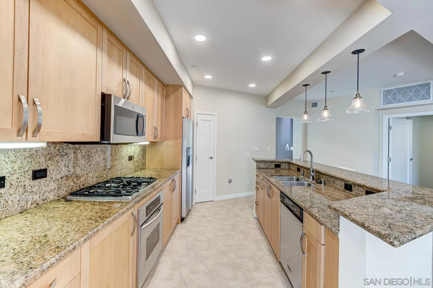 5440 La Jolla Boulevard, Unit E208 La Jolla, CA 92037 - Photo 6 of 35 a kitchen with stainless steel appliances granite countertop a stove and a sink
