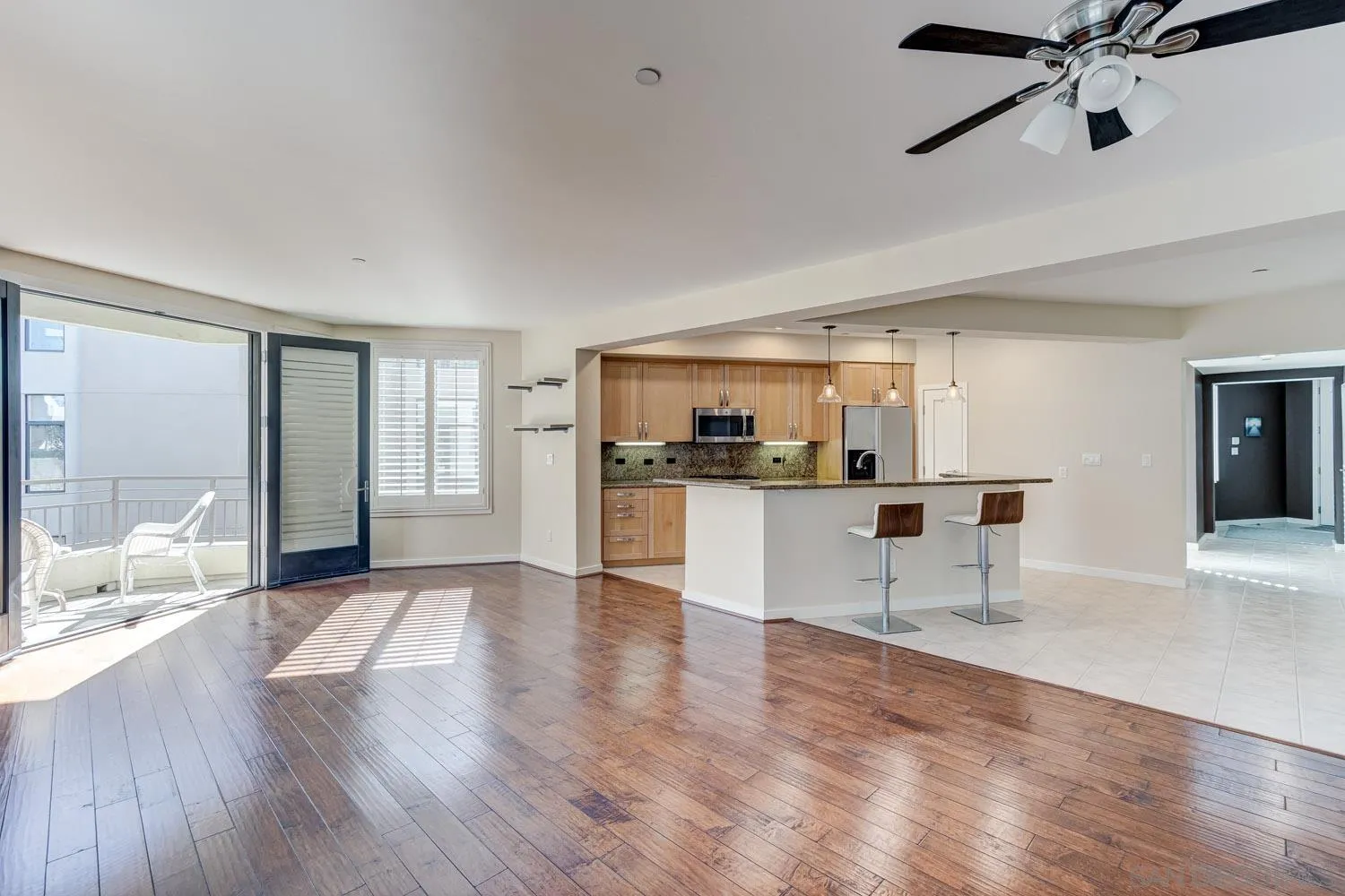 5440 La Jolla Boulevard, Unit E208 La Jolla, CA 92037 - Photo 9 of 35 a view of large living room with wooden floor and windows