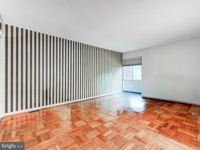 a view of a empty room with wooden floor