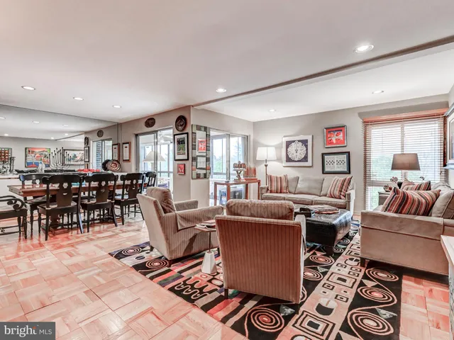 a living room with furniture a rug and a window