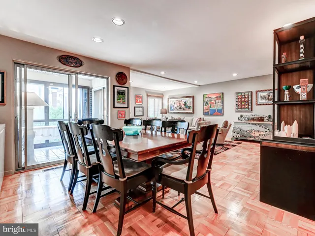 a dining room with furniture and wooden floor