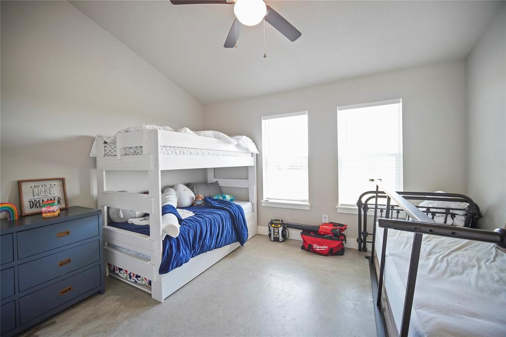 1259 Roney Road Jacksboro, TX 76458 - Photo 8 of 40 a bedroom with furniture and a chandelier