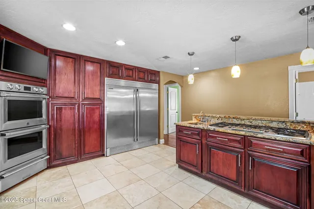 a kitchen with stainless steel appliances granite countertop wooden cabinets a sink and dishwasher