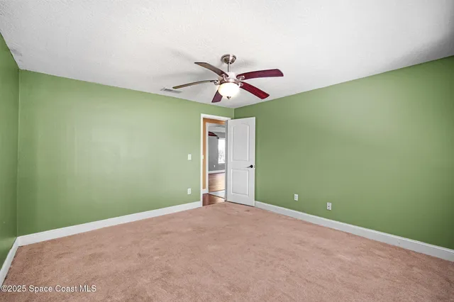 a bathroom with a granite countertop sink a toilet a mirror and shower