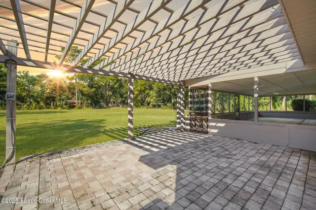 a view of a house with a yard and sitting area
