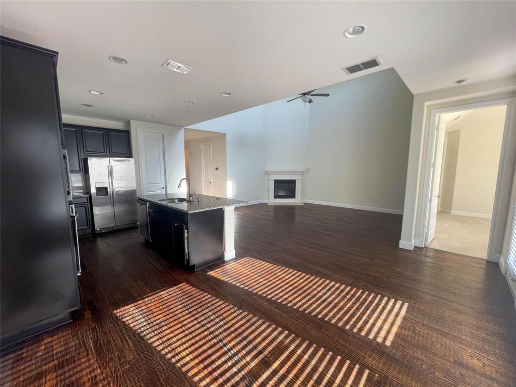 723 Callaway Drive Allen, TX 75013 - Photo 11 of 25 a kitchen with stainless steel appliances a refrigerator and wooden floor