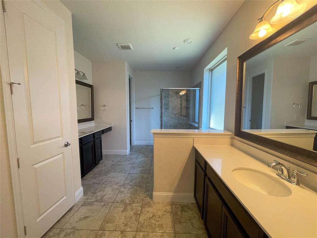 723 Callaway Drive Allen, TX 75013 - Photo 14 of 25 a spacious bathroom with a granite countertop sink and a bathtub