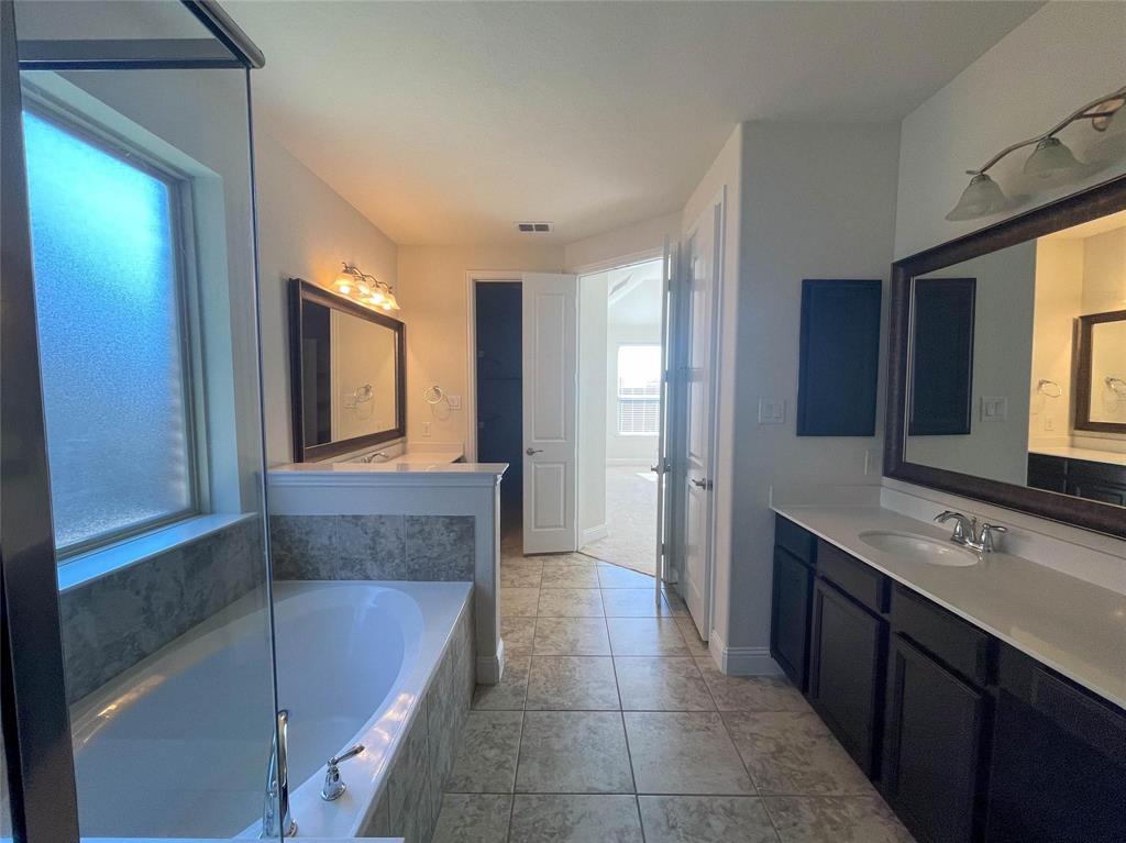 723 Callaway Drive Allen, TX 75013 - Photo 16 of 25 a bathroom with a tub sink and mirror