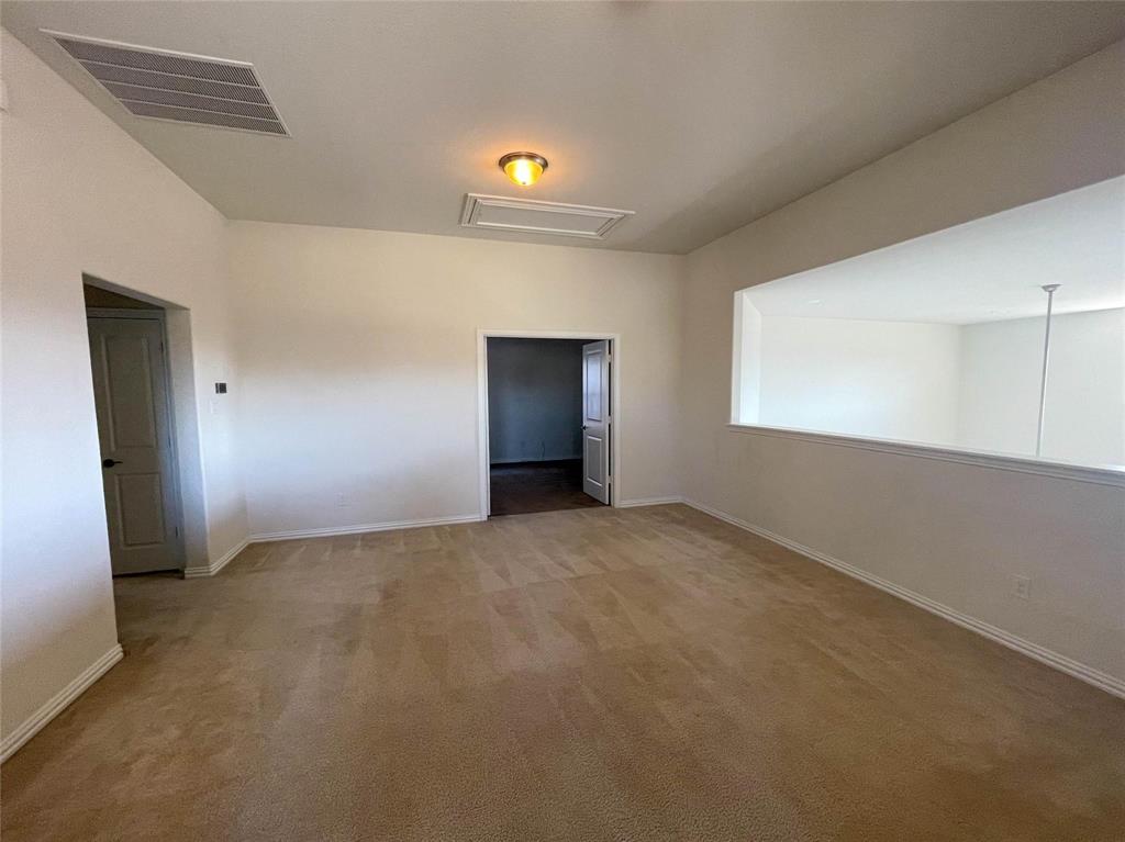 723 Callaway Drive Allen, TX 75013 - Photo 18 of 25 a view of an empty room with window and wooden floor