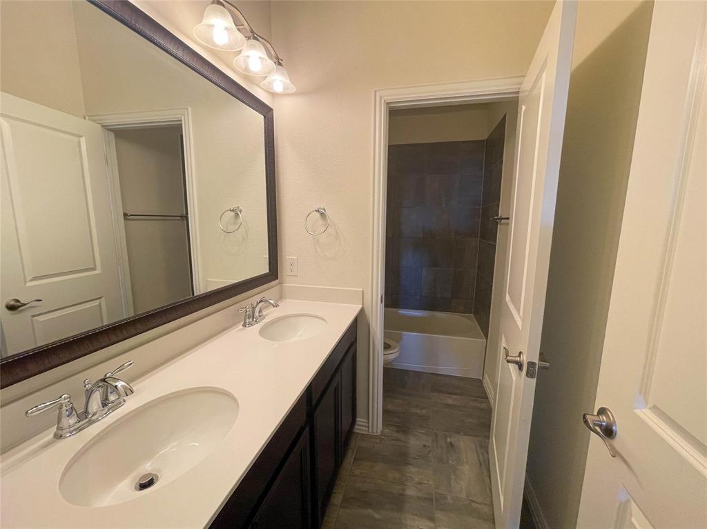723 Callaway Drive Allen, TX 75013 - Photo 23 of 25 a bathroom with a tub sink and mirror