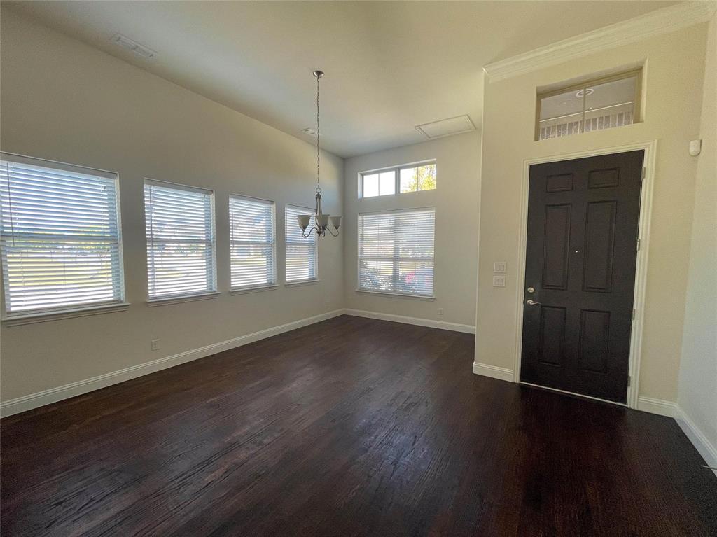 723 Callaway Drive Allen, TX 75013 - Photo 4 of 25 a view of an empty room with wooden floor and a window