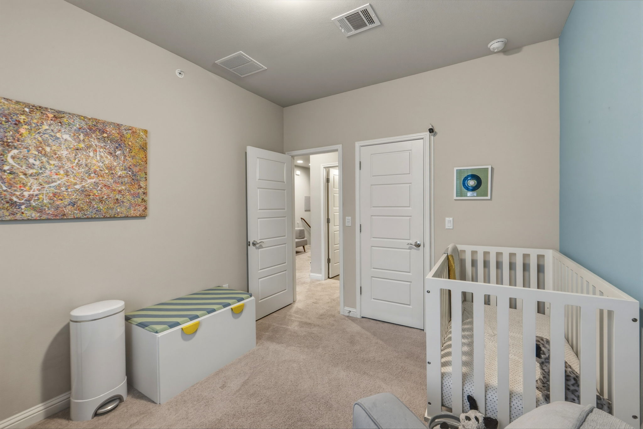 6814 East Riverside Drive, Unit 34 Austin, TX 78741 - Photo 24 of 26 a spacious bedroom with a baby crib and a dresser