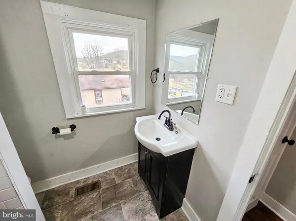 a bathroom with sink and mirror