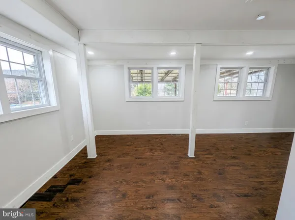 a view of an empty room with windows