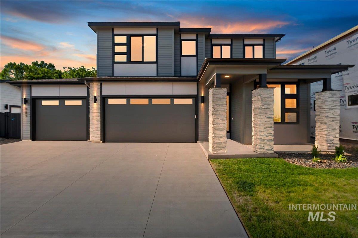 985 West Malbar Street Meridian, ID 83646 - Photo 1 of 39 Modern architectural exterior with a multi-paneled façade, prominent stone-clad pillars, and a flat roofline