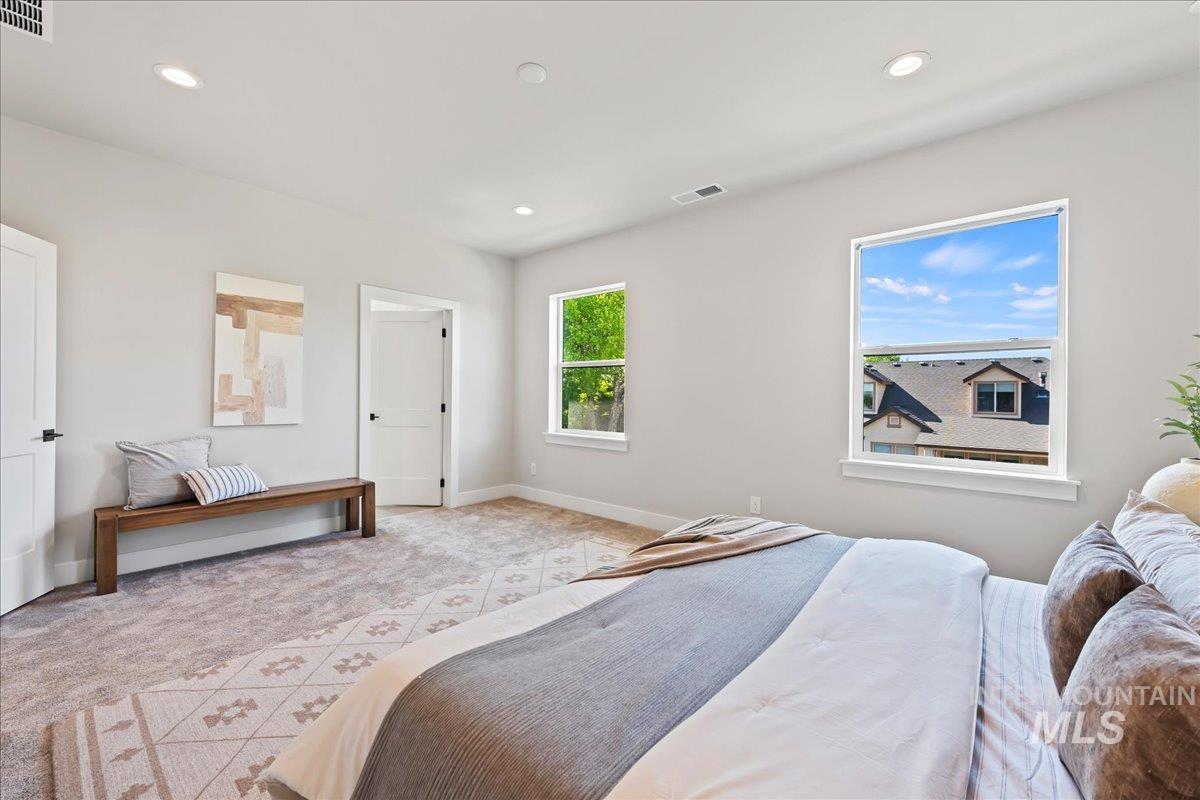 985 West Malbar Street Meridian, ID 83646 - Photo 18 of 39 Carpeted room featuring two windows, recessed lighting, and a white interior door with black hardware