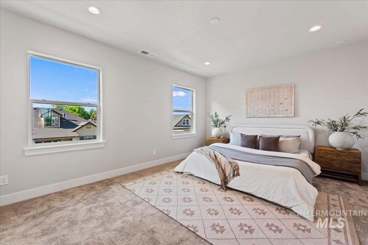 985 West Malbar Street Meridian, ID 83646 - Photo 20 of 39 Spacious room featuring multiple windows, recessed ceiling lighting, wall-to-wall carpeting, and white baseboards